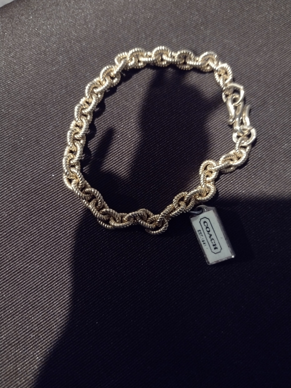 Coach Gold-Tone Twisted Rope Chain Bracelet with Logo Tag
